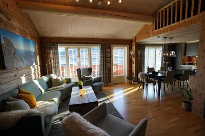 a living room with couches and a dining room at Lake View Apartment 2 bedrooms and loft in Stranda