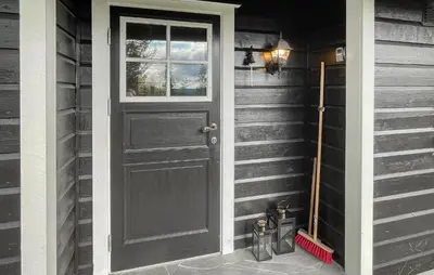 a black door on the side of a house at Lovely Home In Rendalen With Wifi in Rendalen