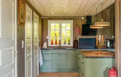 a kitchen with blue cabinets and a sink at Lovely Home In Rendalen With Wifi in Rendalen