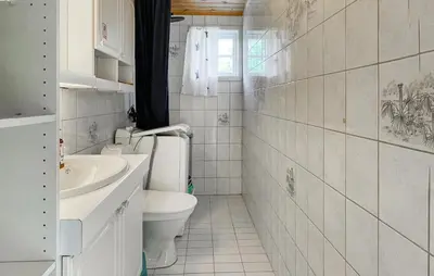 a white bathroom with a toilet and a sink at Lovely Home In Rendalen With Wifi in Rendalen