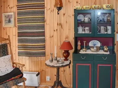 a room with a green cabinet and a table at Seaside Serenity in Settem Fjord-By Traum in Bø