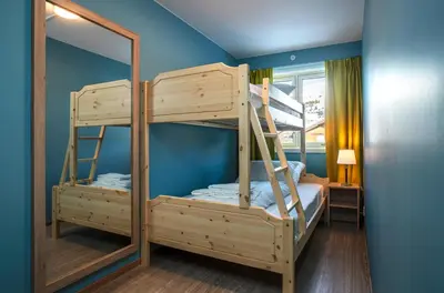 two bunk beds in a room with a mirror at Skeikampen Servicesenter in Svingvoll