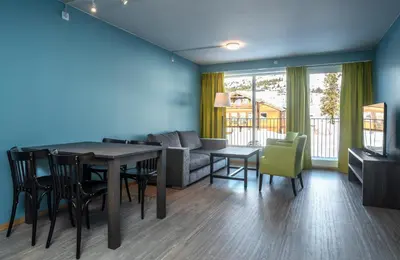 a living room with a table and chairs and a couch at Skeikampen Servicesenter in Svingvoll