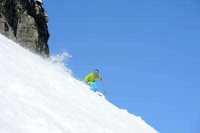 a man is skiing down a snow covered slope at Skeikampen Servicesenter in Svingvoll