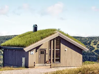 a moss roofed building with a grass roof at 10 person holiday home in Fåvang in Favang