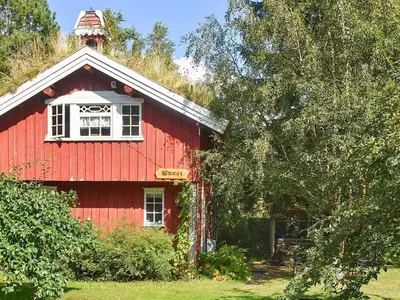 a red barn with a white window and a tower at Vintage Charm by the Sea-By Traum in Bø