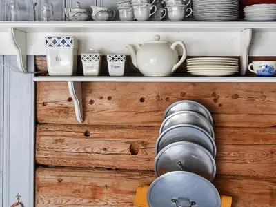 a shelf with plates and cups and dishes on it at Vintage Charm by the Sea-By Traum in Bø