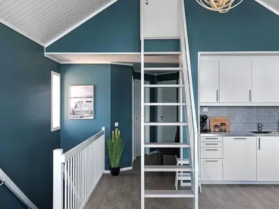 a room with a loft bed and a kitchen at 10 person holiday home in Brattvåg in Brattvåg