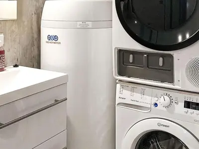 a microwave and a washing machine in a kitchen at 10 person holiday home in Brattvåg in Brattvåg