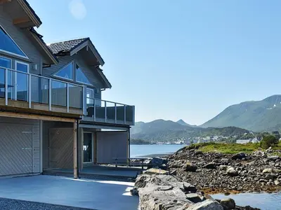 a house on the shore of a body of water at 10 person holiday home in Brattvåg in Brattvåg