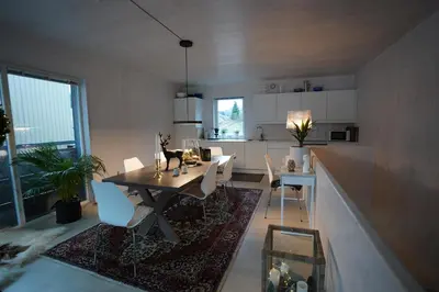 a kitchen and dining room with a table and chairs at Fjord View Apartment in Stranda