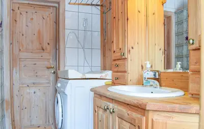 a bathroom with a sink and a washing machine at Cozy Home In Rauland With Wifi in Rauland