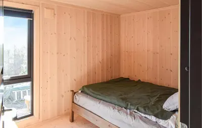 a bedroom with a bed in a room with a window at 4 Bedroom Beautiful Home In Sjusjøen in Sjusjøen