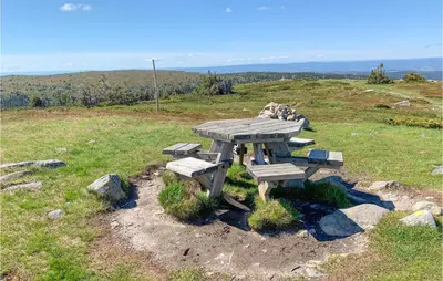 a picnic table sitting on top of a hill at 4 Bedroom Beautiful Home In Sjusjøen in Sjusjøen