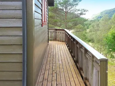a wooden walkway on the side of a house at 4 person holiday home in Leirvik i Sogn in Leirvik