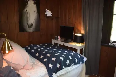 a bedroom with an american flag blanket on a bed at Skeikampen Booking in Svingvoll