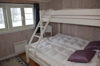 a bunk bed with a ladder in a room at Skeikampen Booking in Svingvoll