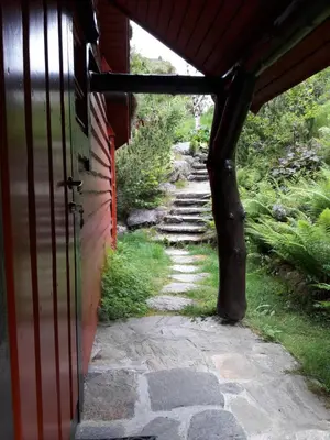 an entrance to a building with a stone path at Troll Fjordhytter in Syvde