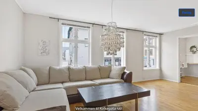a living room with a couch and a table at Central apartment in walking distance from the city. in Ålesund