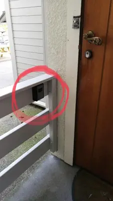 a red hose is sticking out of a door at Central apartment in walking distance from the city. in Ålesund