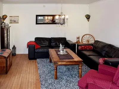 a living room with couches and a coffee table at 10 person holiday home in MIDSUND in Midsund