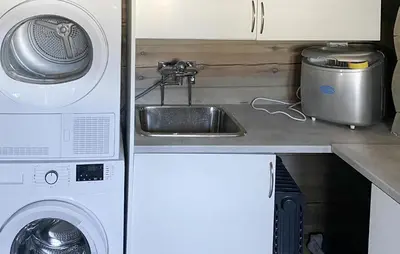 a kitchen with a sink and a washing machine at Pet Friendly Home In Hovden I Setesdal in Hovden