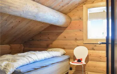 a room with a bed in a wooden cabin at Pet Friendly Home In Hovden I Setesdal in Hovden