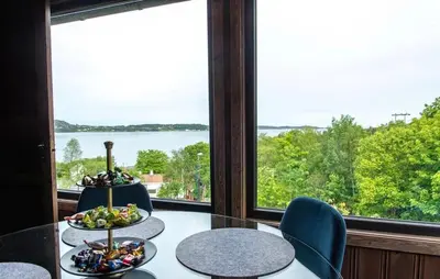 a dining room with two tables and a large window at Atlantic View Ingerstua in Frei