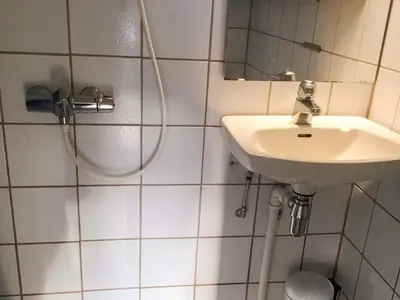 a white bathroom with a sink and a shower at 6 person holiday home in averøy-By Traum in Averoy