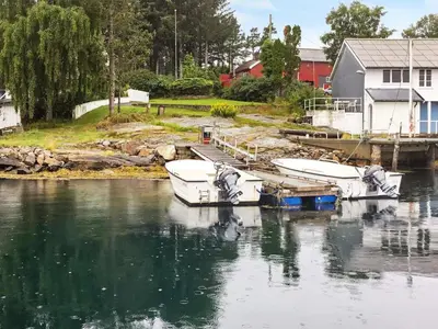 a group of boats docked at a dock in the water at 6 person holiday home in averøy-By Traum in Averoy