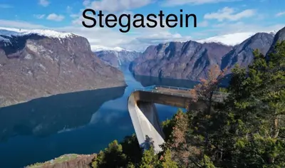 a bridge over a lake in the mountains at Two bedroom apartement in Sogndal