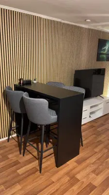 a black desk with chairs and a television in a room at Two bedroom apartement in Sogndal