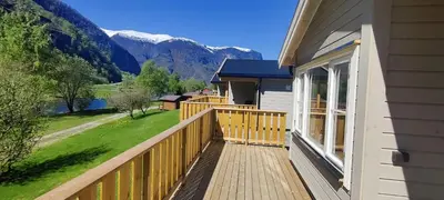 a porch of a house with a view of the mountains at Lunde Camping in Aurland