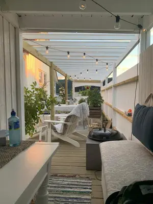 a patio with a table and chairs on a balcony at The Gingerbread House in Lillehammer