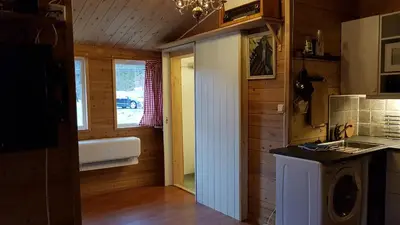 a kitchen with a sink and a washing machine at Leilighet 2240 in Haugsvær