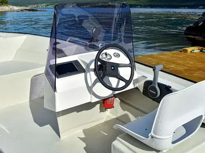 a boat with a steering wheel on the front at 6 person holiday home in Seim in Seim