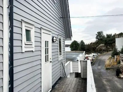 a white house with a white door and a driveway at 6 person holiday home in Seim in Seim