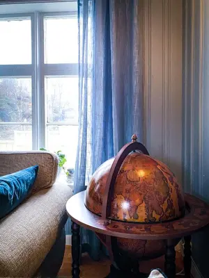 a room with a table with a large globe on it at Villa Edvin - Slow living in Eide