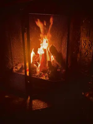 a fireplace with a fire in it at night at Villa Edvin - Slow living in Eide