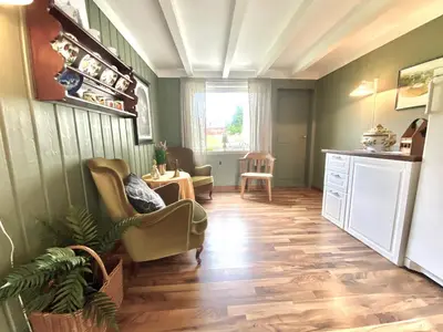a living room with chairs and a table at Villa Edvin - Slow living in Eide