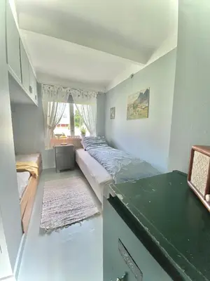 a bed in a room with a green counter at Villa Edvin - Slow living in Eide