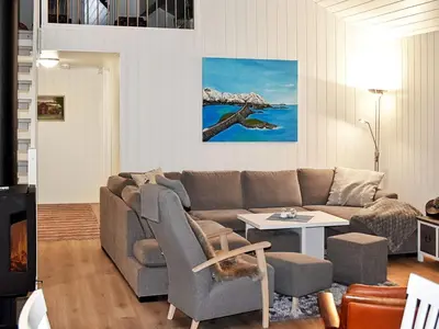 a living room with a couch and a table at 6 person holiday home in Lyngstad in Lyngstad