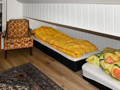 a bedroom with a bed and a chair at 6 person holiday home in Lyngstad in Lyngstad