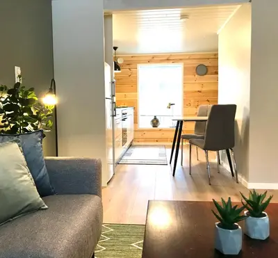 a living room with a couch and a table at Villa Lovise Riverside in Stranda