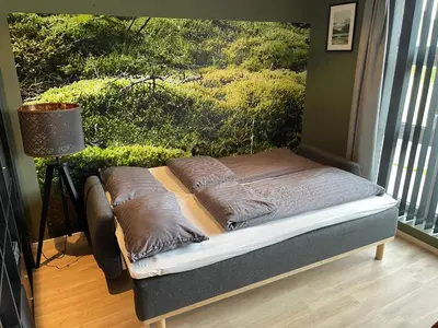 a bed with two pillows on it in a room at Apartment Lilletveitvegen in Bergen