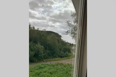 a window with a view of a field of trees at Moldegaard Riding Lodge in Moldegard