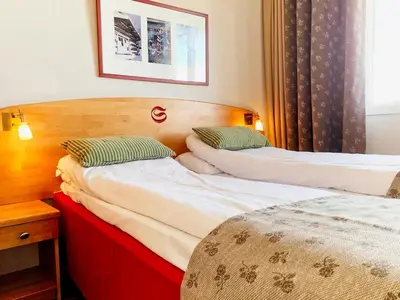 a hotel room with two beds and a window at Savalen Fjellhotell & Spa in Tynset