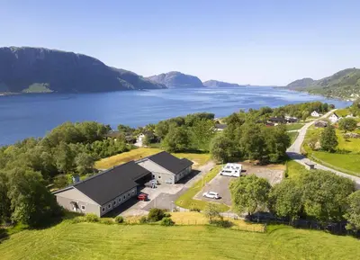 an aerial view of a building next to a lake at Sognhostel in Sørbø