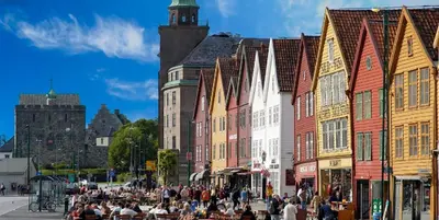 a crowd of people walking on a street in front of buildings at Nedre Stølen Apartment Bergen in Bergen