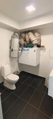 a bathroom with a toilet in a room at Lagunen Apartments in Bergen